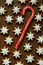 Traditional German Christmas Cookies Home Baked Glazed Cinnamon Stars with Nuts Candy Cane Pattern on Rusty Dark Background
