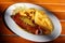 Traditional German currywurst, served with chips on a white plate. Wooden table as background