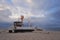 Traditional german fishing boat on the beach of Baltic sea in the sunset before storm.