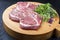 Traditional German raw beef cheeks with herb and spice on a modern design wooden cutting board