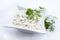 Traditional German remoulade with gherkin and dill design bowl on a white board