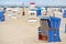 Traditional German roofed wicker beach chairs on the beach of Baltic sea. Beach with chairs on stormy day. Ostsee.