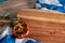 A traditional German salted bread and the Bavarian flag on a wooden surface