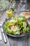 Traditional German summer lettuce with curled lettuce, goat cheese and mango dressing on a plate on a well laid table