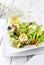 Traditional German summer lettuce with curled lettuce, goat cheese and mango dressing on a plate on a well laid table