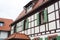 Traditional german village half-timbered house with wooden decoration and green shutters of the windows