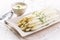 Traditional German white asparagus with sauce hollandaise on a design plate