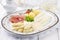 Traditional German white asparagus with serrano ham and boiled potatoes on a classic design plate