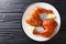 Traditional glazed sticky chicken leg quarters served with lemon closeup on a plate. Horizontal top view