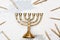 Traditional golden Hanukkah candleholder and candles on white ba