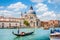 Traditional Gondola on Canal Grande with Basilica di Santa Maria della Salute in Venice