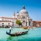 Traditional Gondola on Canal Grande with Basilica di Santa Maria della Salute, Venice, Italy