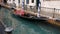 Traditional gondola moored in water canal in Venice