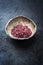 Traditional gourmet red wine salt in a earthenware bowl