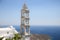 Traditional greek church bell tower and the Aegean sea in Tinos, Greece