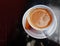 Traditional Greek coffe in white porcelain cup on dark background