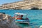 Traditional greek fishing boat stays parked near beach of Matala town on Crete island, Greece