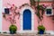 Traditional greek house with colorful blue door and pink walls at Asos village. Assos peninsula famous and extremely