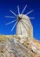 Traditional Greek mill on top of mountain on blue sky background, bright Sunny day, Crete, Greece