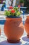 Traditional greek red flowerpot with flowers