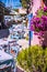 Traditional greek vivid colored tavern on the narrow Mediterranean street on hot summer day