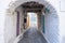 Traditional greek whitewashed buildings, cobblestone streets and stone structure arch. Ioulida village,Tzia, Kea island, Greece