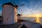 Traditional greek windmills on Mykonos island at sunrise, Cyclades, Greece