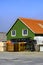 Traditional Green Painted House With Lobster And Crab Pots Stacked Outside Against