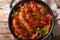 Traditional grilled sausages with multicolored peppers, onions and tomatoes close-up in a pan. horizontal top view