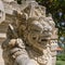 Traditional guard demon statue carved in dark stone in Bali