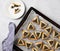 Traditional Hamantaschen cookies for the Jewish holiday on black cooking board