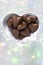 Traditional handmade gingerbread heart cookies with filling chocolate glazed on bright lighted background