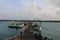 Traditional harbor in the morning with several fishing boats alongside and people activities at Masalembu Island, Indonesia.