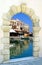 Traditional harbor through an old door in Crete is