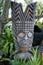 A traditional Hawaiian totem or wood carving with a fierce warrior to ward off evil spirits.