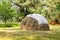 Traditional haystack in the meadow, harvested by farmers by hand. The summer harvest. Harvesting hay for the winter for