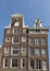 Traditional historic Dutch gable houses beside canal in Amsterdam