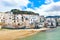 Traditional historical houses on the coast of Tyrrhenian sea in Sicilian Cefalu, Italy. Behind the houses there is rock