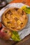 Traditional homemade apple pie with nuts and cinnamon close up a