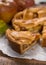 Traditional homemade apple pie with nuts and cinnamon close up a