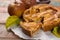 Traditional homemade apple pie with nuts and cinnamon close up a