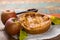 Traditional homemade apple pie with nuts and cinnamon close up a