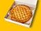 Traditional homemade rustic baked pie with seasonal fruit or meat filling in cardboard box isolated on white. Fast food to go.