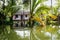 Traditional house in the Kerala backwaters in the lush jungle along the canal, Alappuzha - Alleppey, India