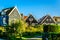 Traditional houses with green boarded wall and red tile roof in the small historic fishing village of Marken