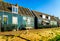 Traditional houses with green boarded wall and red tile roof in the small historic fishing village of Marken