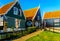 Traditional houses with green boarded wall and red tile roof in the small historic fishing village of Marken