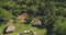 Traditional houses of Indonesia village at tropical green landscape aerial view. Unique buildings