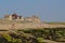 Traditional houses on the north sea of in Audresselles, France, with beach and mossy rock coast in front