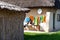 Traditional houses with reed roofs and washed clothes left out to dry on a wire in the wind, in a Romanian village near Black Sea